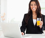 Beautiful woman in suit relaxing with her laptop 