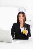 Attractive woman in suit relaxing with her laptop 