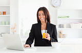 Charming woman in suit relaxing with her laptop 