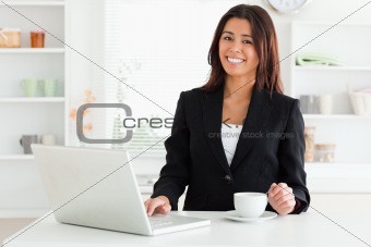 Attractive woman in suit enjoying a cup of coffee while relaxing