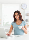 Charming woman enjoying a cup of coffee while relaxing 