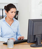 Beautiful woman working on a computer while sitting