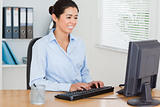 Attractive woman working on a computer while sitting