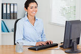 Good looking woman working on a computer while sitting