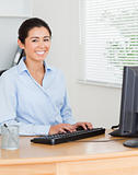 Charming woman working on a computer while sitting