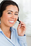 Portrait of a good looking woman with a headset helping customer