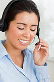 Portrait of a charming woman with a headset helping customers