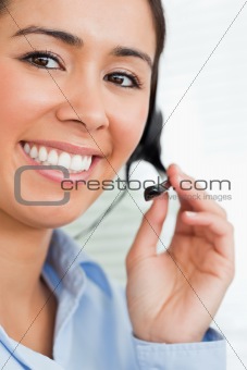Portrait of a beautiful female with a headset helping customers 
