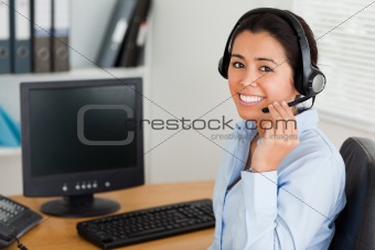Beautiful woman wearing a headset and discussing while sitting