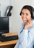 Attractive woman wearing a headset and discussing while sitting
