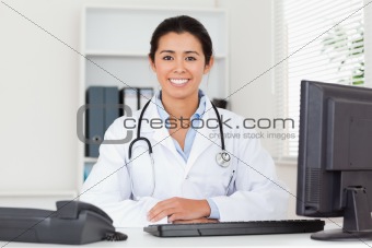 Pretty woman doctor with a stethoscope posing