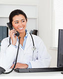 Beautiful woman doctor on the phone while sitting