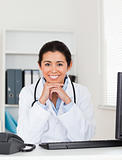 Beautiful woman doctor posing while sitting