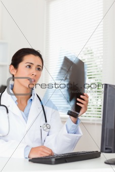 Attractive female doctor looking at a x-ray