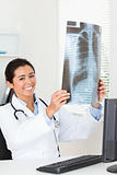 Cute female doctor looking at a x-ray