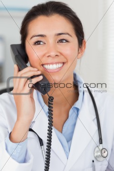 Beautiful female doctor on the phone and posing