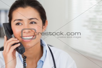 Attractive female doctor on the phone and posing