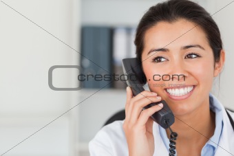 Good looking female doctor on the phone and posing