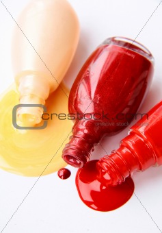 multi-colored nail polish  for hands spilled on a white background