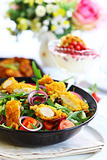 Gourmet salad with curry chicken stripes