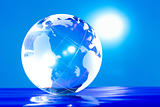 Glass globe with bright highlights on a blue background