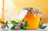 sweet honey in glass jars with flowers