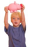 Boy shows a piggy bank