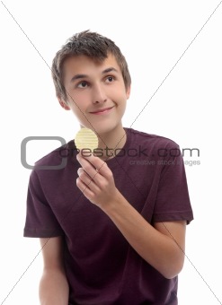 Boy with potato crisp looking sideways