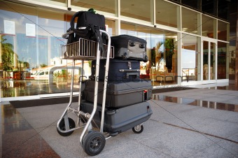 Trolley with suitcases in front of hotel