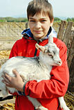 Teenage boy with little goat