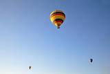 three hot air balloons clear blue sky