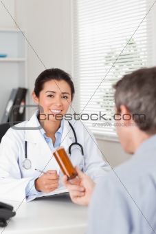 Patient holding a box of pills given by his doctor