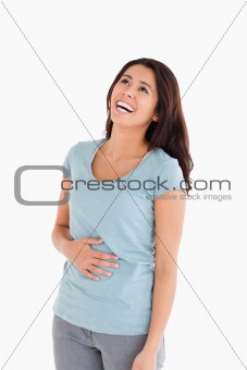 Joyful beautiful woman laughing while standing