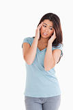 Attractive woman having a headache while standing