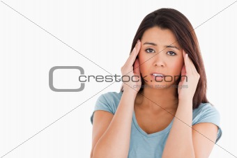 Portrait of a beautiful woman having a headache while standing