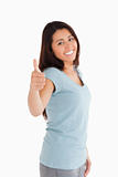 Good looking woman having her thumb up while standing