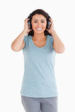 Attractive woman using her headphones while posing