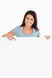 Beautiful woman pointing at a board