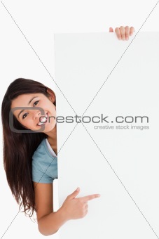 Good looking woman pointing at a board