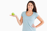 Good looking woman holding a green apple
