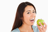 Lovely woman eating a green apple
