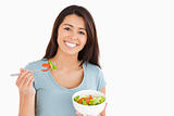 Beautiful woman eating a bowl of salad