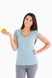 Good looking woman holding an orange