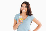 Attractive woman holding a glass of orange juice