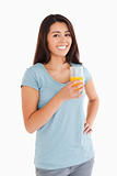 Beautiful woman holding a glass of orange juice