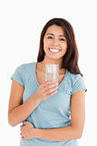 Gorgeous woman holding a glass of water