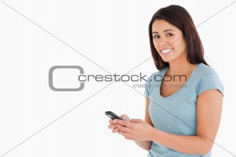 Gorgeous woman writing a text on her mobile phone
