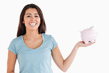 Beautiful female holding a piggy bank