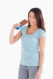 Attractive woman eating a chocolate bar