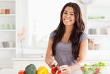 Attractive woman cooking vegetables while standing